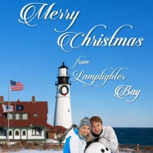 Couple building snowman by coastal lighthouse